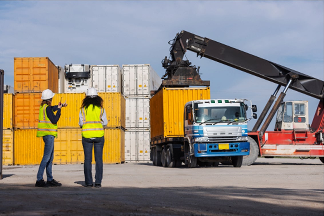 two-female-workers-oversee-container-loading-opera-2025-07-06-05-33-36-utc 1-min